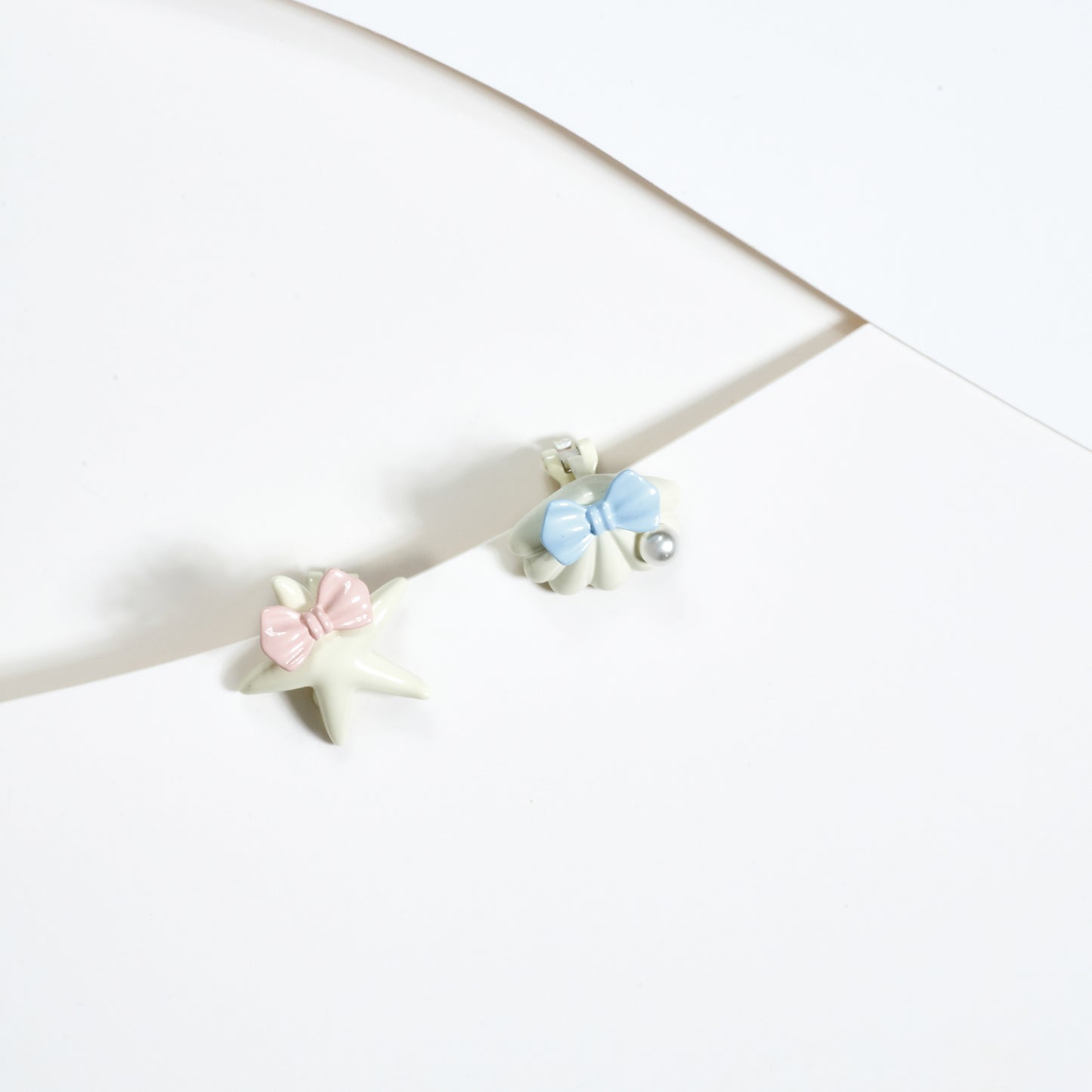 Aretes de Clip Estrella y concha de mar en Acero